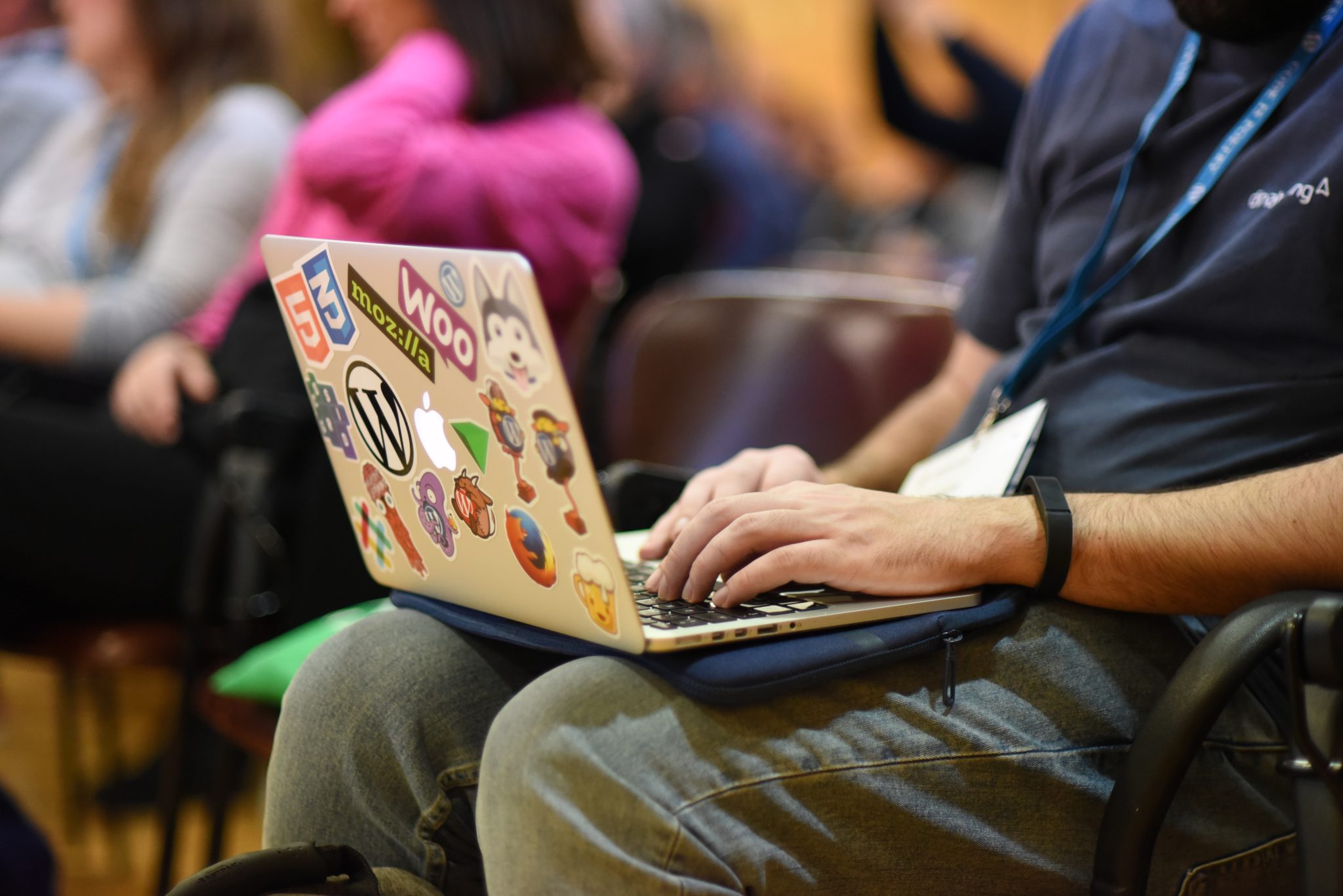 Person taking notes on a laptop at a WordCamp.